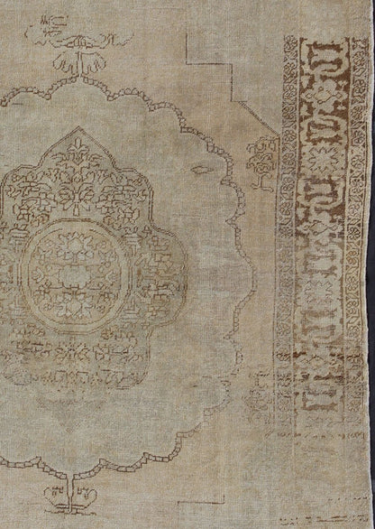Antique Oushak Carpet in Taupe, Brown, Light Celadon Green and Neutral Colors Measures: 8'0'' x 12'1''. This antique Oushak wool rug features an over - sized medallion with detailed vines and flowers. A framework of floral motifs and styliz... - Keivan Woven ArtsEN - 141449 - 7203Rug