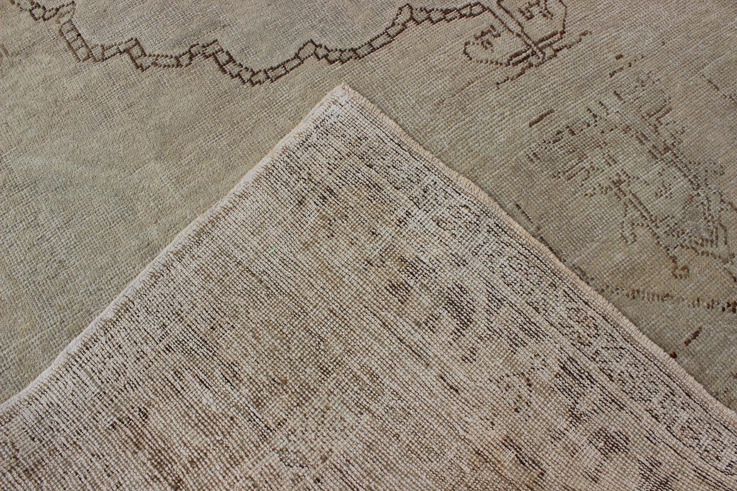 Antique Oushak Carpet in Taupe, Brown, Light Celadon Green and Neutral Colors Measures: 8'0'' x 12'1''. This antique Oushak wool rug features an over - sized medallion with detailed vines and flowers. A framework of floral motifs and styliz... - Keivan Woven ArtsEN - 141449 - 7203Rug