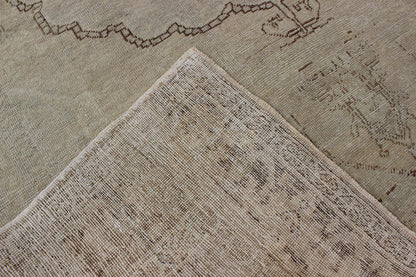 Antique Oushak Carpet in Taupe, Brown, Light Celadon Green and Neutral Colors Measures: 8'0'' x 12'1''. This antique Oushak wool rug features an over - sized medallion with detailed vines and flowers. A framework of floral motifs and styliz... - Keivan Woven ArtsEN - 141449 - 7203Rug