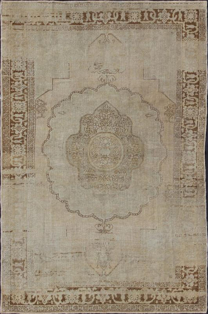 Antique Oushak Carpet in Taupe, Brown, Light Celadon Green and Neutral Colors Measures: 8'0'' x 12'1''. This antique Oushak wool rug features an over - sized medallion with detailed vines and flowers. A framework of floral motifs and styliz... - Keivan Woven ArtsEN - 141449 - 7203Rug