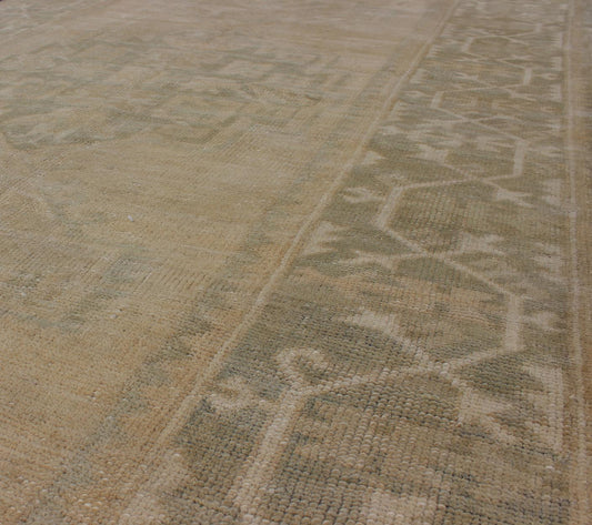Medallion Vintage Turkish Oushak Rug in Taupe, Green and Sand Colors This vintage Turkish Oushak rug (circa mid - 20th century) features a unique blend of colors and an intricately beautiful design. The central three medallions, two more faint tha... - Keivan Woven ArtsEN - 141655 - 6710Rug