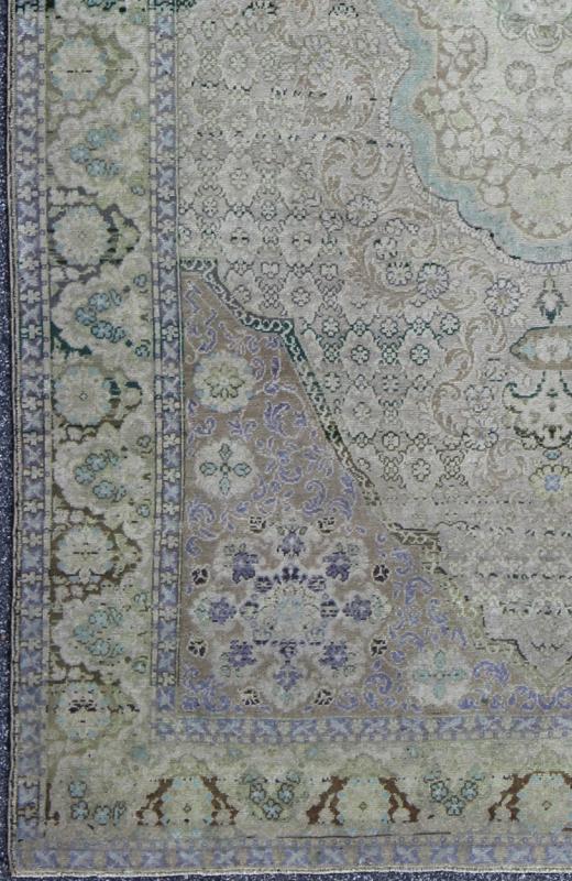 Vintage Turkish Rug with European Design in Various Shades of Lavender and Green This beautiful rug from mid - 20th century Turkey features a traditionally European design. The faint cream ground is home to the elaborate center medallion and surr... - Keivan Woven ArtsEN - 141743 - 6765Rug