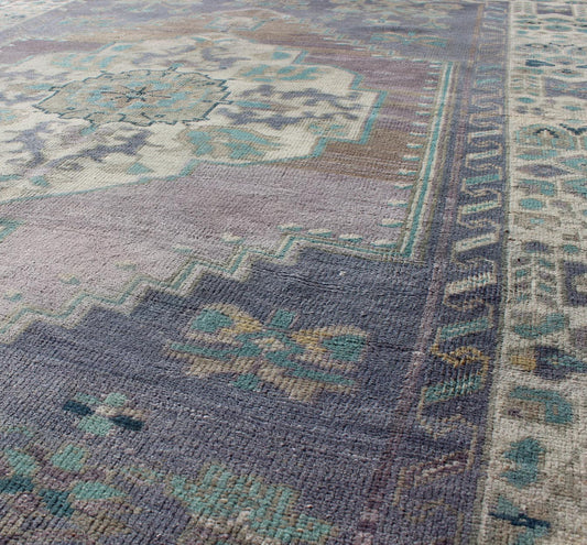 Purple and Teal Vintage Turkish Oushak Rug with Floral Layered Medallion Design Measures: 5'0 x 6'6''. This vintage Turkish Oushak rug features an intricately beautiful design with a floral aesthetic. The central medallion is surrounded by mu... - Keivan Woven ArtsEN - 141744 - 6769Rug