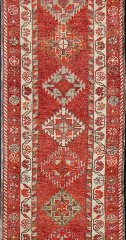 Vintage Turkish Oushak Runner with Medallions in Rust Red and Multi Colors Measures: 2'7'' x 11'6''. This Oushak runner from mid - 20th century Turkey features an all - over multi - medallion design rendered in geometric patterns and a wide variety... - Keivan Woven ArtsEN - 141745 - 7715Rug