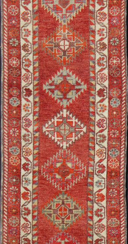 Vintage Turkish Oushak Runner with Medallions in Rust Red and Multi Colors Measures: 2'7'' x 11'6''. This Oushak runner from mid - 20th century Turkey features an all - over multi - medallion design rendered in geometric patterns and a wide variety... - Keivan Woven ArtsEN - 141745 - 7715Rug