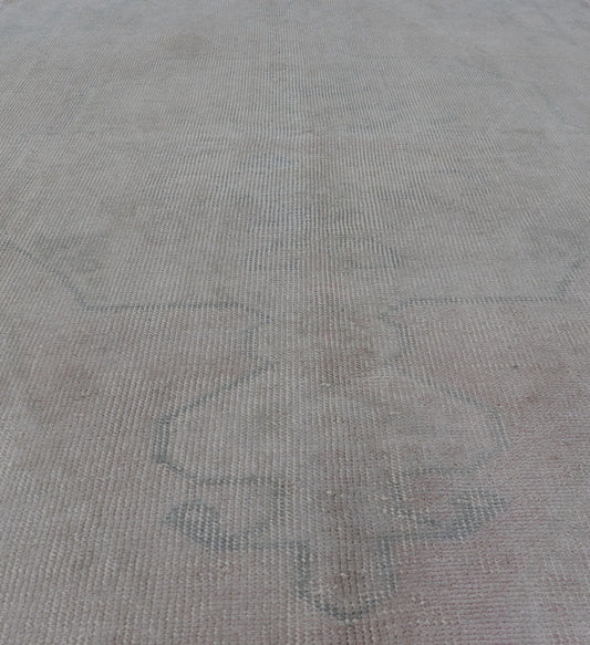 Vintage Turkish Medallion Oushak with All - Over Muted Tones of Neutral Colors Measures 4'5 x 7'0 The taupe - sandy color field homes a muted central medallion decorated in muted blue and pink. Tones of faded light green can be found within... - Keivan Woven ArtsEN - 142089 - 10940Rug