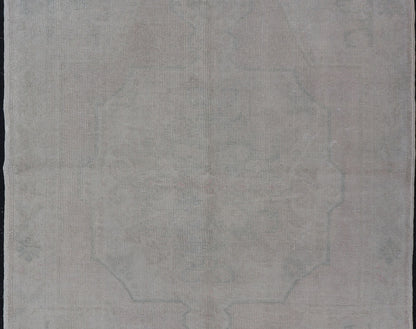 Vintage Turkish Medallion Oushak with All - Over Muted Tones of Neutral Colors Measures 4'5 x 7'0 The taupe - sandy color field homes a muted central medallion decorated in muted blue and pink. Tones of faded light green can be found within... - Keivan Woven ArtsEN - 142089 - 10940Rug