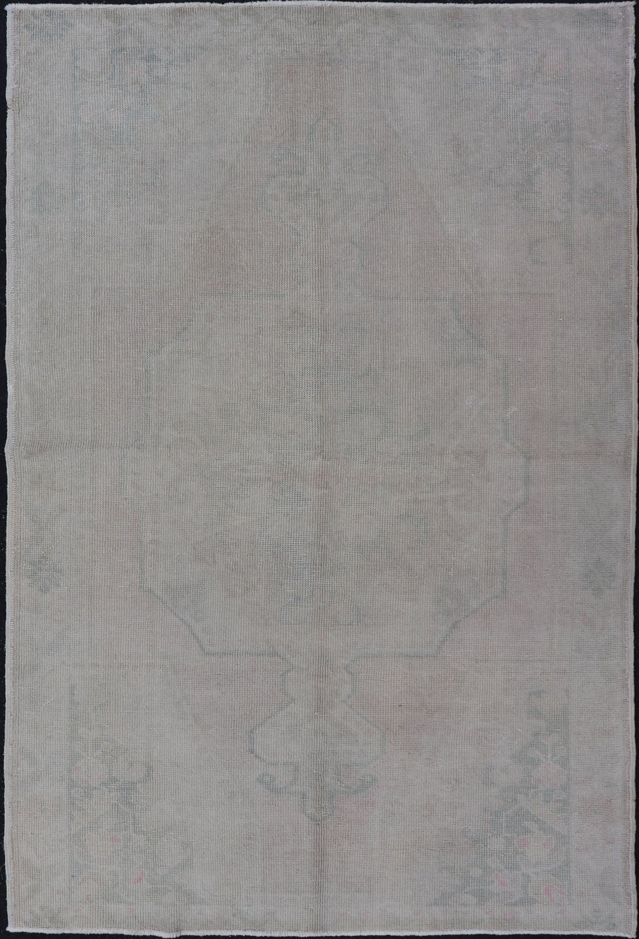 Vintage Turkish Medallion Oushak with All - Over Muted Tones of Neutral Colors Measures 4'5 x 7'0 The taupe - sandy color field homes a muted central medallion decorated in muted blue and pink. Tones of faded light green can be found within... - Keivan Woven ArtsEN - 142089 - 10940Rug