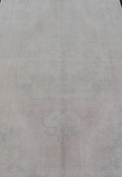 Vintage Turkish Medallion Oushak with All - Over Muted Tones of Neutral Colors Measures 4'5 x 7'0 The taupe - sandy color field homes a muted central medallion decorated in muted blue and pink. Tones of faded light green can be found within... - Keivan Woven ArtsEN - 142089 - 10940Rug