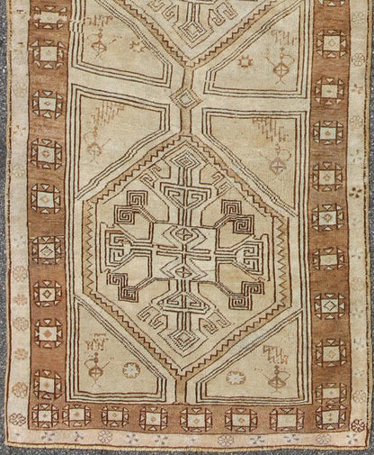 Brown, Camel, Ivory Long Turkish Oushak Runner with Geometric Tribal Medallions This vintage Turkish Oushak gallery rug (circa mid - 20th century) features a unique blend of colors and an intricately beautiful design. The central medallions consis... - Keivan Woven ArtsEN - 142368 - 8379Rug