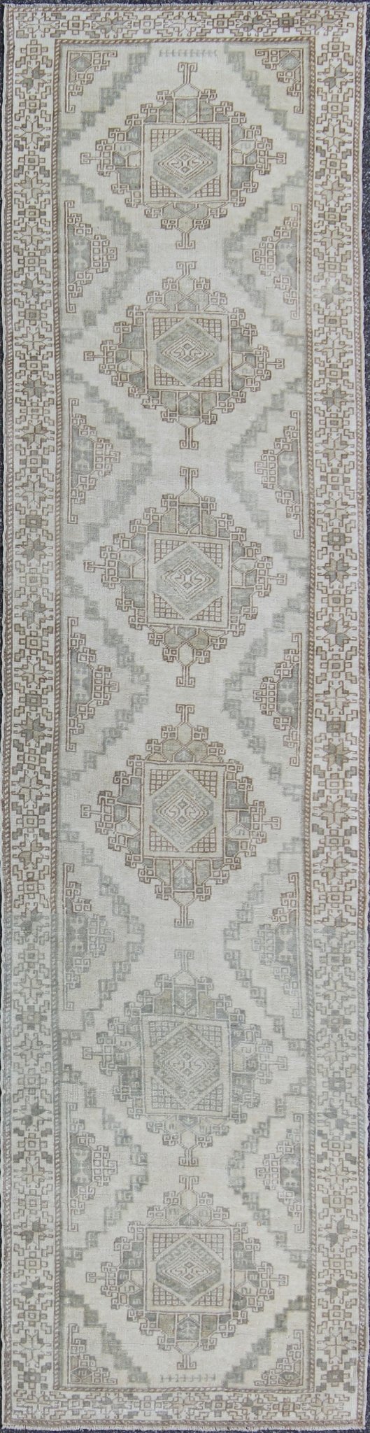 Vintage Oushak Runner with Central Medallions and Ornate Border Measures: 3'0'' x 12'3''. This beautiful vintage Oushak runner features a classic Oushak design, which is enhanced by lustrous wool. The faint ivory ground is home to six large a... - Keivan Woven ArtsEN - 142470 - 7855Rug