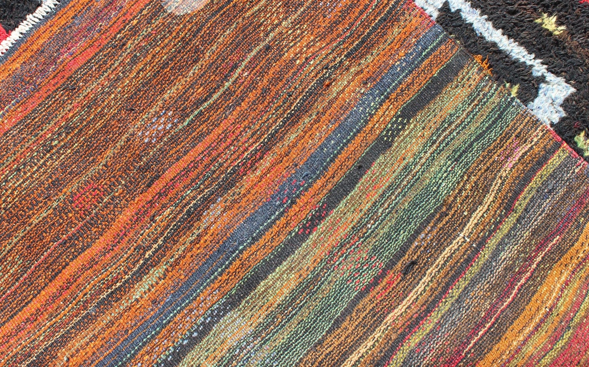 Vintage Turkish Tulu Rug with Tribal Pattern in Black, Yellow, Red, Blue and Red. Keivan Woven Arts / rug EN - 142568, country of origin / type: Turkey / Tulu, circa mid - 20th century Measures: 3'11 x 5'11. This vintage Tulu from mid - 20th century Tu... - Keivan Woven ArtsEN - 142568 - 7859Rug