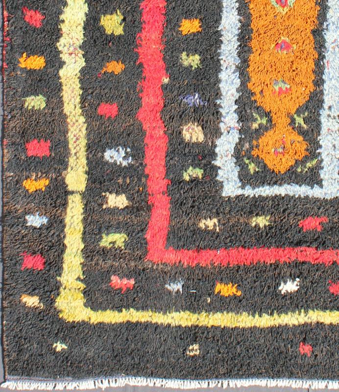 Vintage Turkish Tulu Rug with Tribal Pattern in Black, Yellow, Red, Blue and Red. Keivan Woven Arts / rug EN - 142568, country of origin / type: Turkey / Tulu, circa mid - 20th century Measures: 3'11 x 5'11. This vintage Tulu from mid - 20th century Tu... - Keivan Woven ArtsEN - 142568 - 7859Rug
