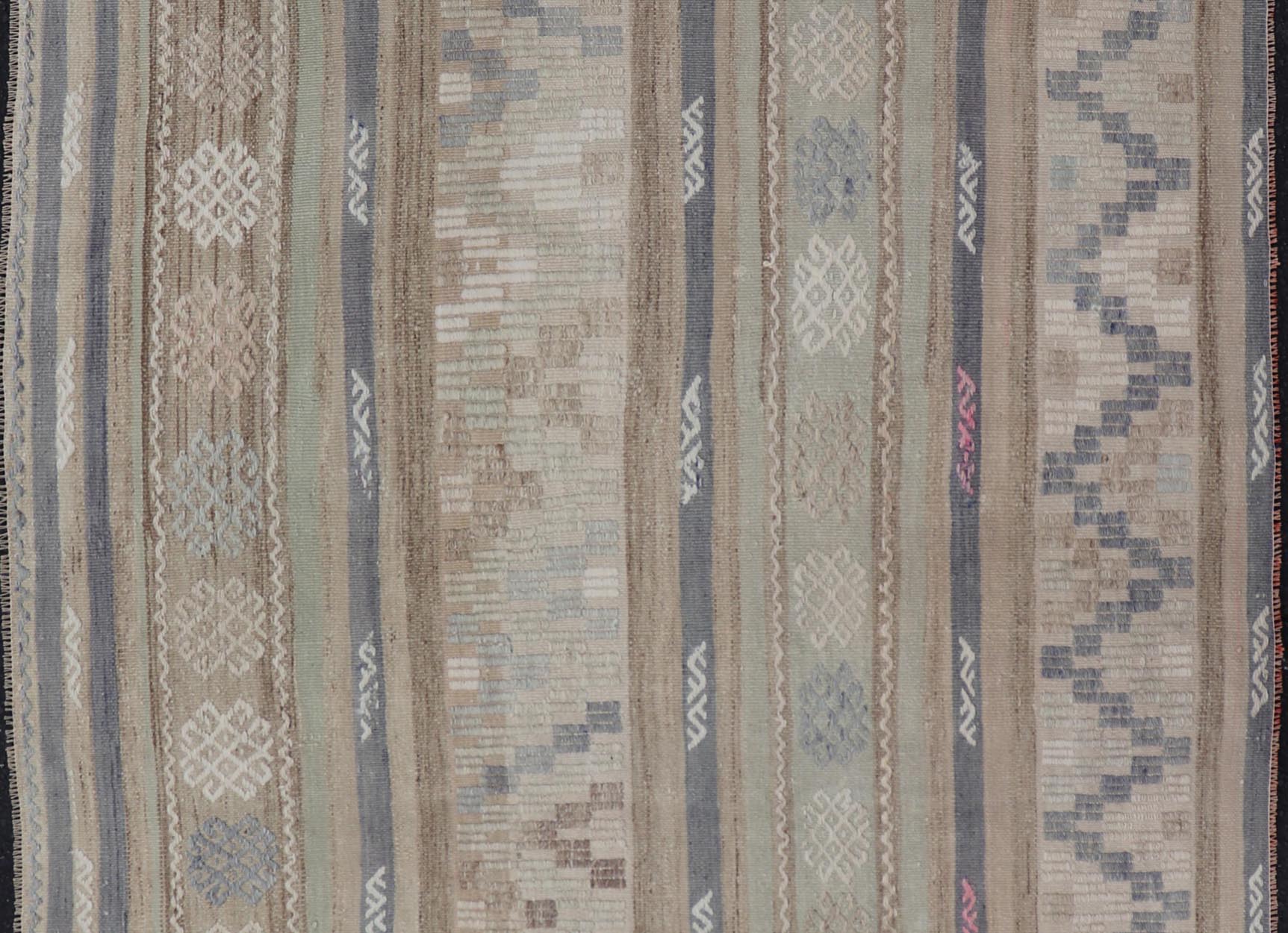 This flat - woven Kilim from Turkey features an enticing composition consisting of stripes with fascinating geometric designs rendered in natural tones of brown and gray, as well as some light green shades. Vintage Kilim with Stripes and Geometri... - Keivan Woven ArtsEN - 14668 - 23971Rug