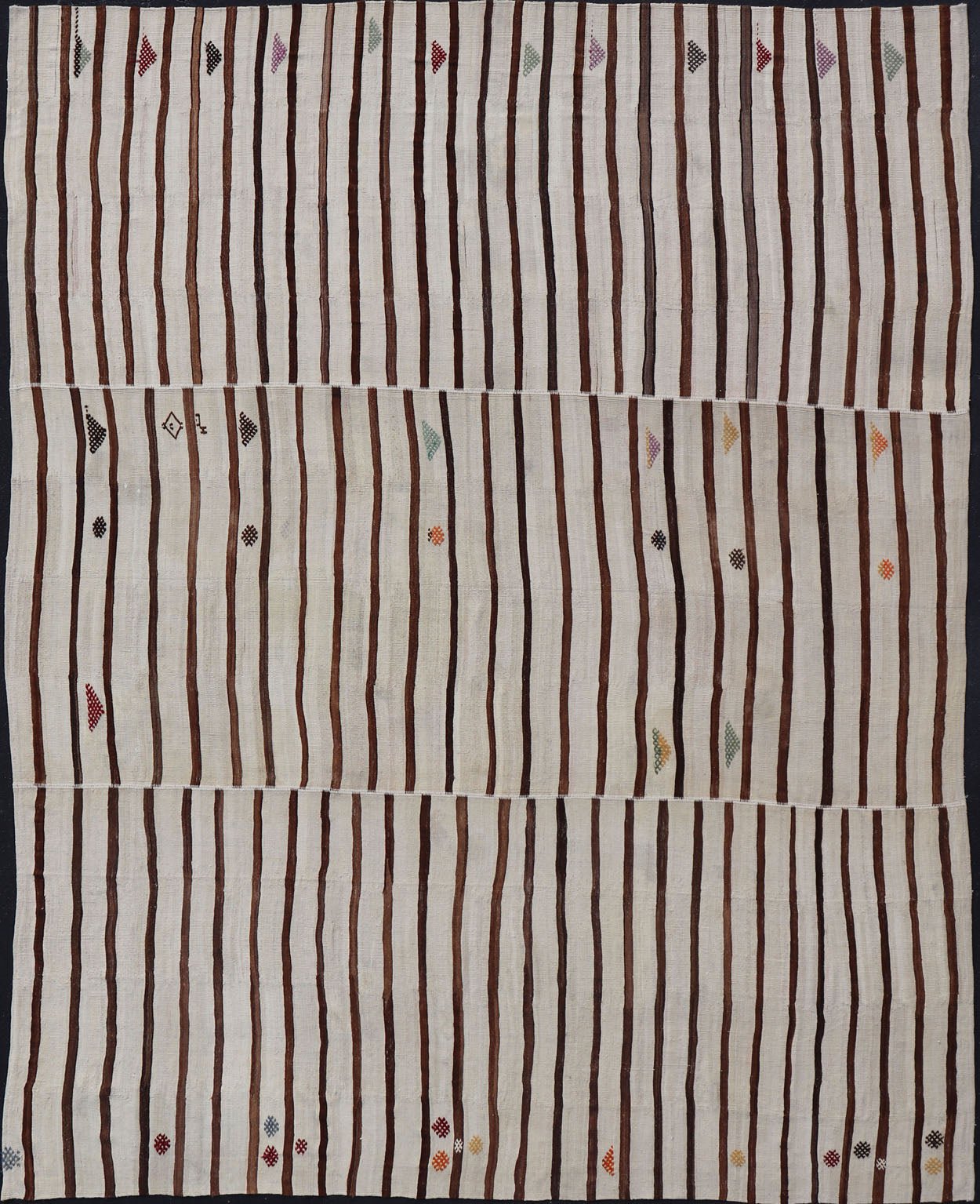 Measures: 14'8 x 18'6 This flat - weave tribal Turkish kilim has been hand - woven in wool. The rug features an all - over sub - geometric striped panel design, rendered in earthy tones; making this rug a superb fit for a wide variety of interiors. ... - Keivan Woven ArtsEN - 14854 - 22812Rug