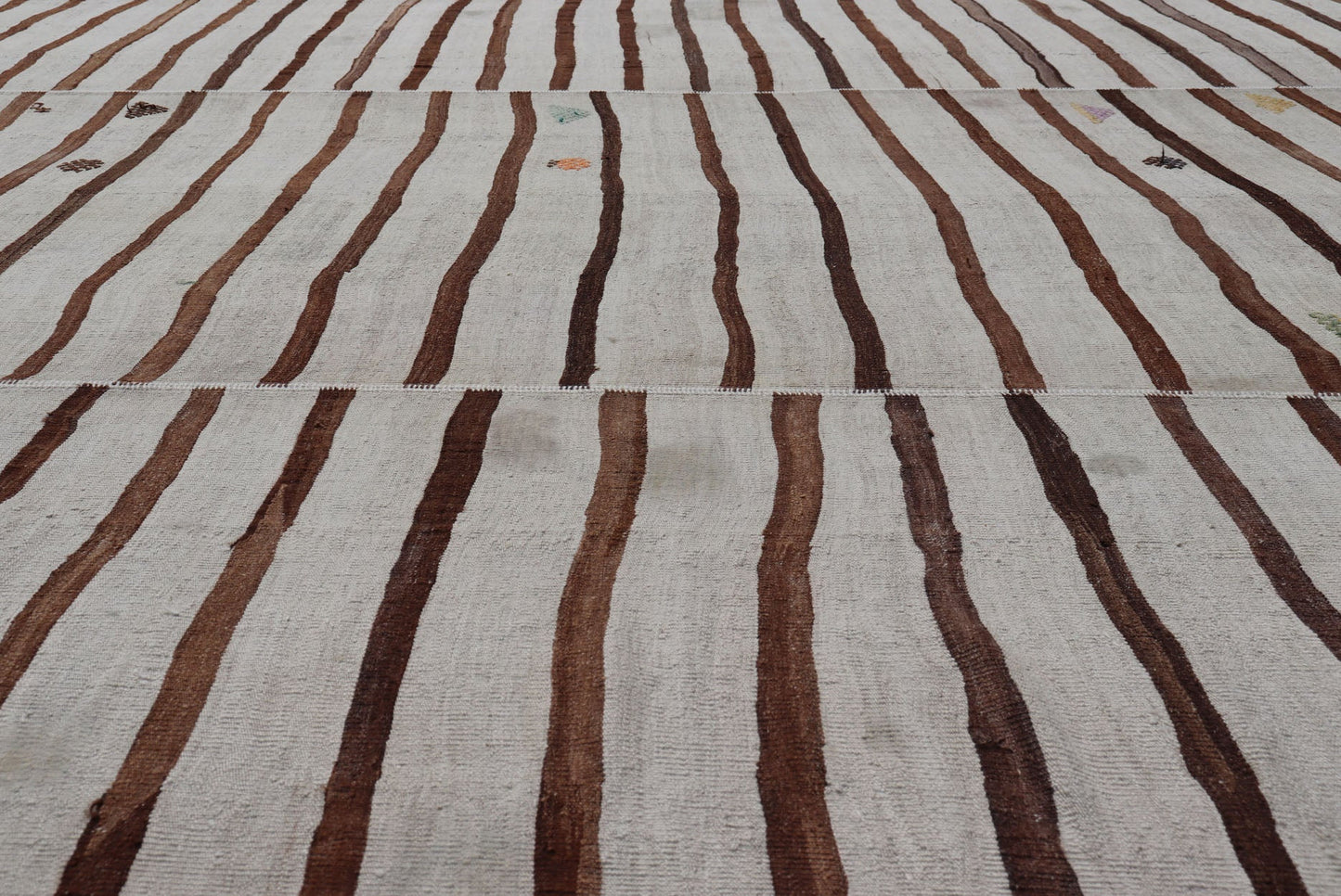 Measures: 14'8 x 18'6 This flat - weave tribal Turkish kilim has been hand - woven in wool. The rug features an all - over sub - geometric striped panel design, rendered in earthy tones; making this rug a superb fit for a wide variety of interiors. ... - Keivan Woven ArtsEN - 14854 - 22812Rug