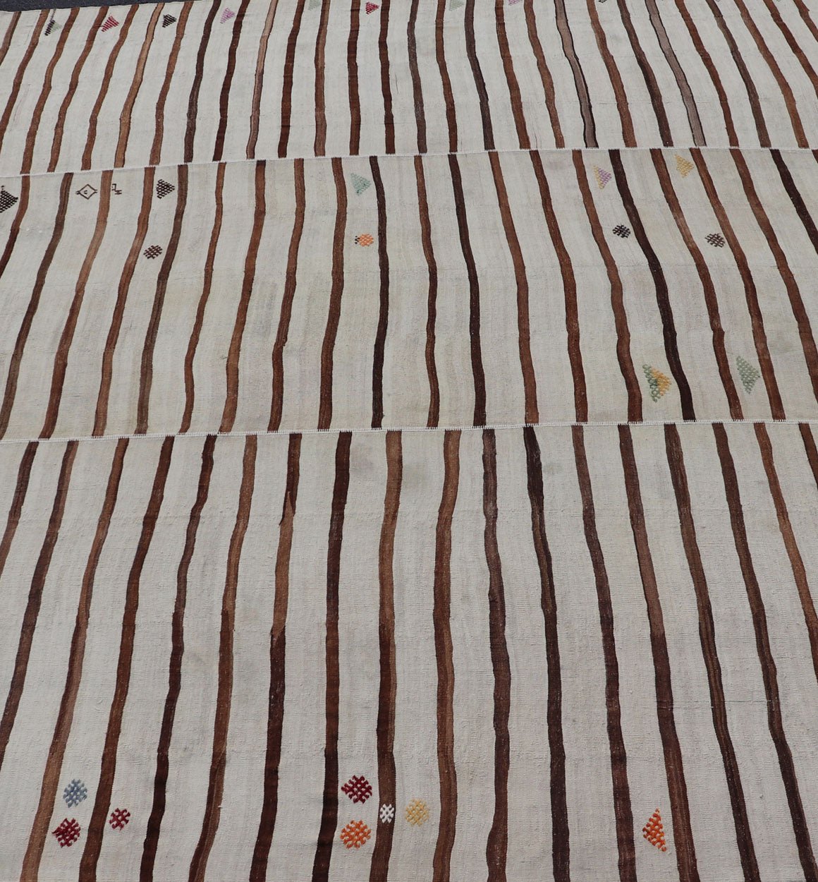 Measures: 14'8 x 18'6 This flat - weave tribal Turkish kilim has been hand - woven in wool. The rug features an all - over sub - geometric striped panel design, rendered in earthy tones; making this rug a superb fit for a wide variety of interiors. ... - Keivan Woven ArtsEN - 14854 - 22812Rug