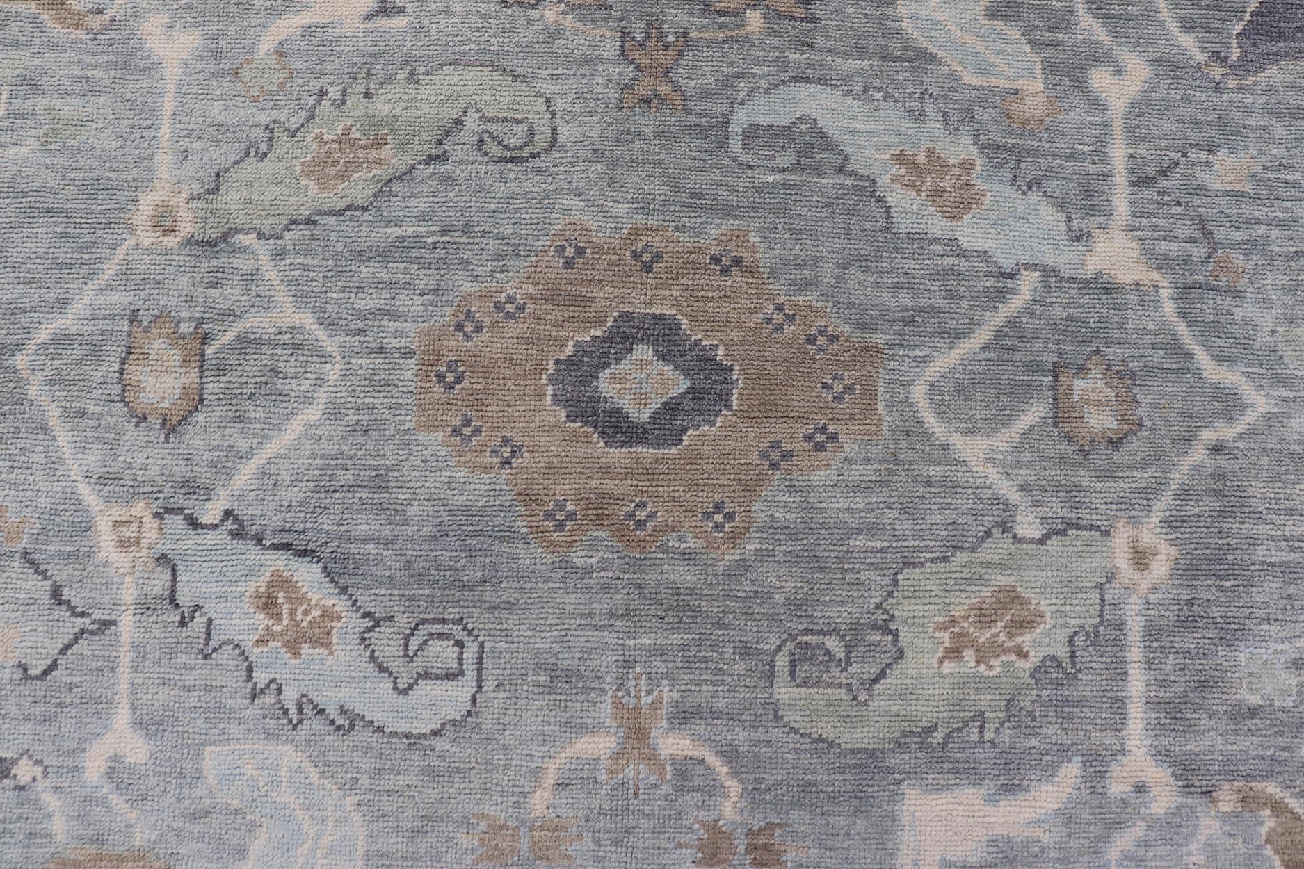 Measures: 10'7 x 14'7 Tribal Floral Design Hand Knotted Turkish Oushak Rug with Blues and Brown. rug EN - 15202, country of origin / type: Turkey / Oushak / Keivan Woven Arts This unique design Oushak rug from Turkey features a bold design wi... - Keivan Woven ArtsEN - 15202 - 22422Rug