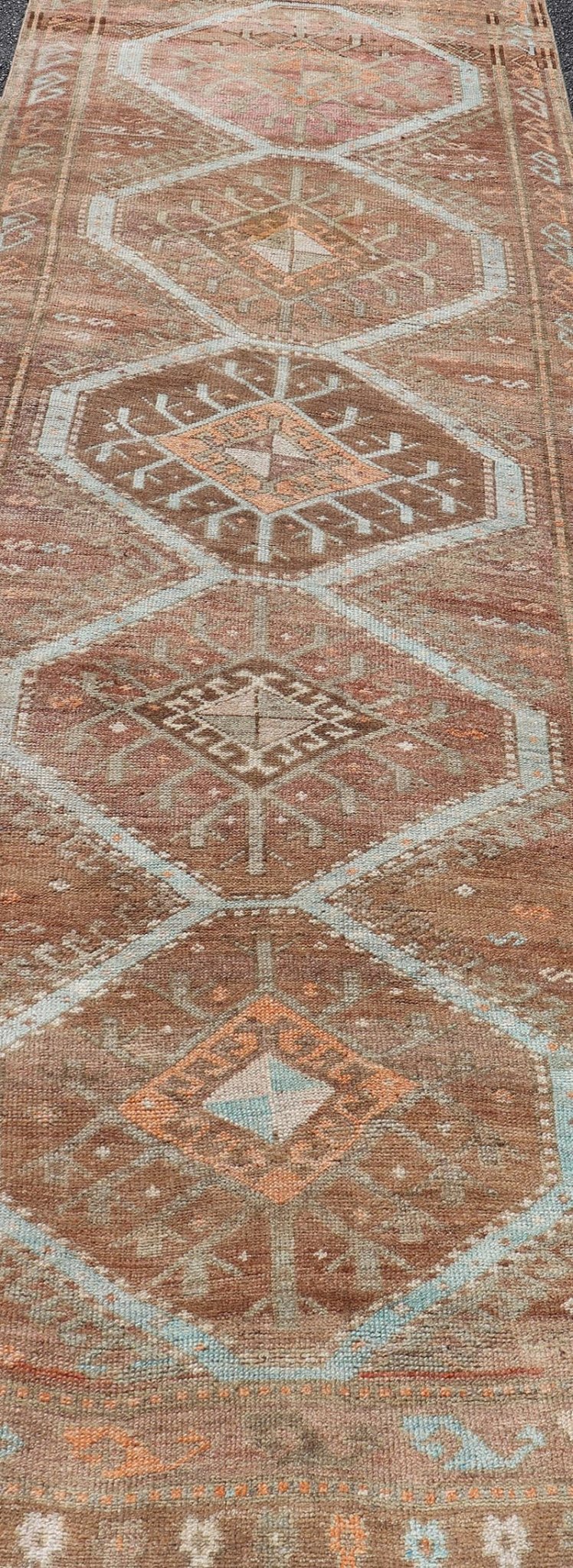 Colorful Turkish Kars Runner in Softer Tones with Tribal and Geometric Motifs. Keivan Woven Arts / rug/EN - 15341, country of origin / type: Turkey / Oushak, circa 1930 Measures: 3'9 x 10'9 This Unique & Colorful Turkish Kars runner featu... - Keivan Woven ArtsEN - 15341 - 23607Rug