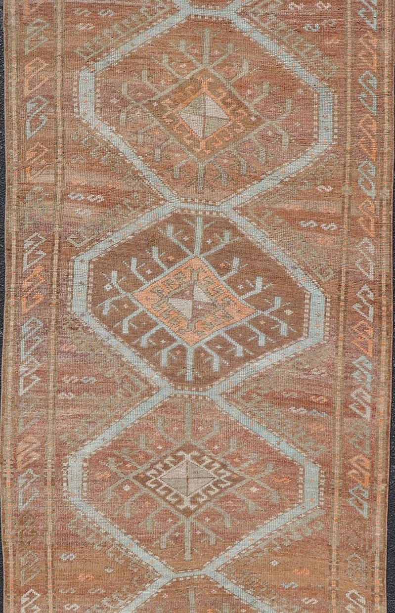 Colorful Turkish Kars Runner in Softer Tones with Tribal and Geometric Motifs. Keivan Woven Arts / rug/EN - 15341, country of origin / type: Turkey / Oushak, circa 1930 Measures: 3'9 x 10'9 This Unique & Colorful Turkish Kars runner featu... - Keivan Woven ArtsEN - 15341 - 23607Rug