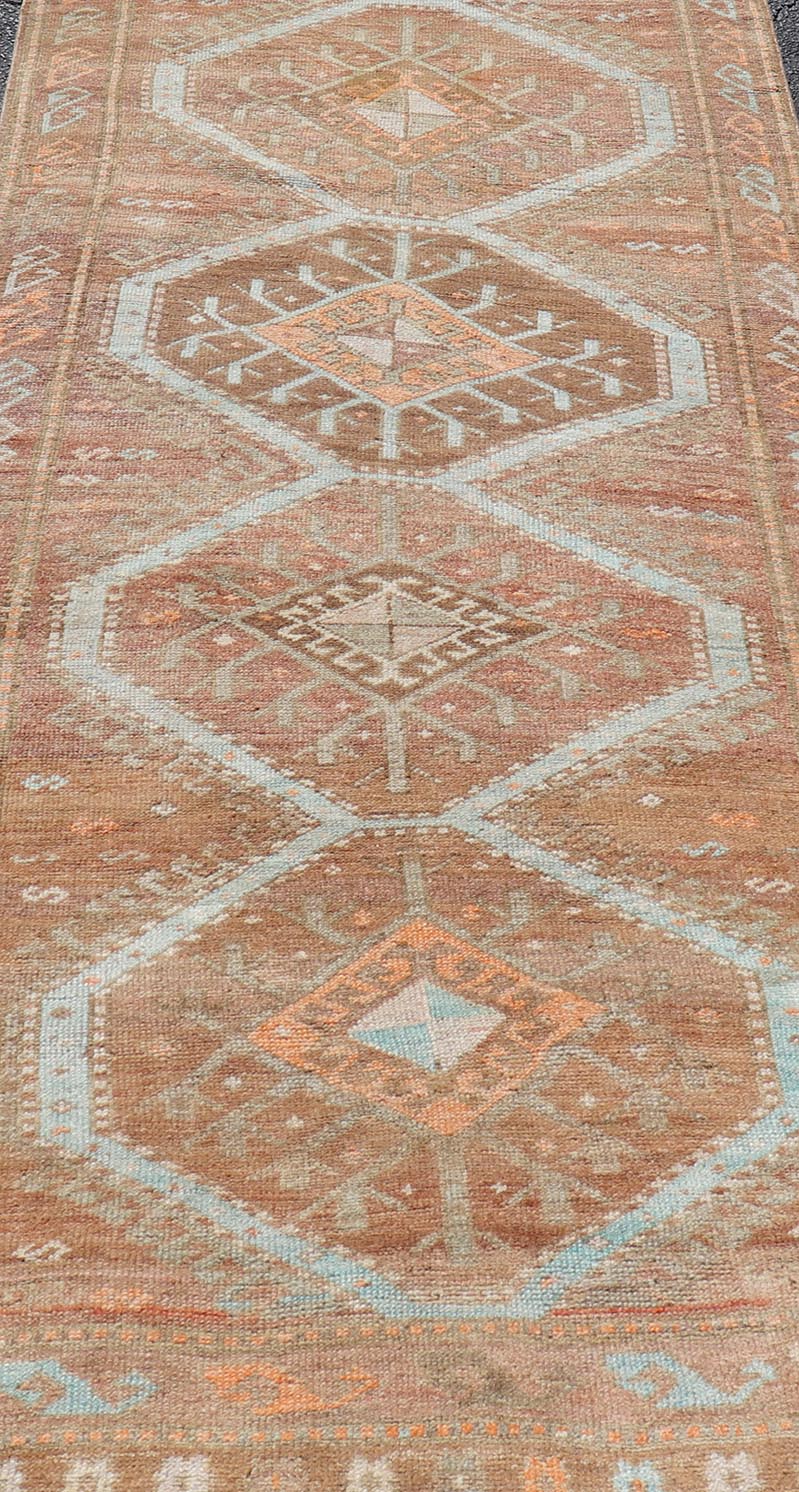 Colorful Turkish Kars Runner in Softer Tones with Tribal and Geometric Motifs. Keivan Woven Arts / rug/EN - 15341, country of origin / type: Turkey / Oushak, circa 1930 Measures: 3'9 x 10'9 This Unique & Colorful Turkish Kars runner featu... - Keivan Woven ArtsEN - 15341 - 23607Rug