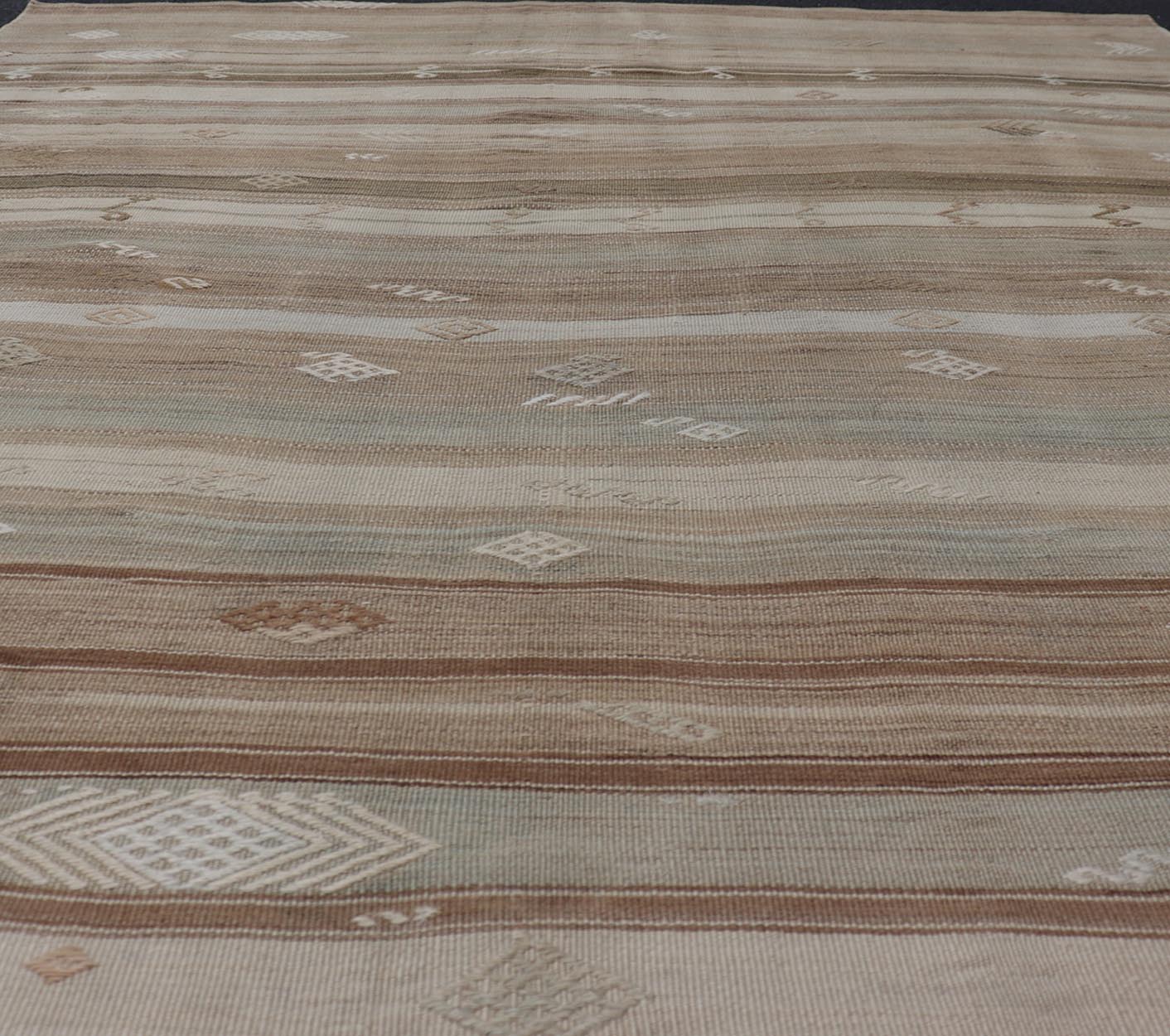 Vintage Kilim With Subtle Striped Patterns in Earth Tones Measures: 6'4" x 7'10" This Vintage Turkish Kilim showcases a flat weave with subtle patterns scattered across horizontal stripes. The kilim is decorated with shades of beige, bro... - Keivan Woven ArtsEN - 15524 - 25853Rug