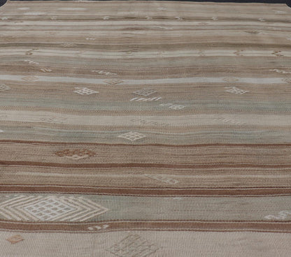 Vintage Kilim With Subtle Striped Patterns in Earth Tones Measures: 6'4" x 7'10" This Vintage Turkish Kilim showcases a flat weave with subtle patterns scattered across horizontal stripes. The kilim is decorated with shades of beige, bro... - Keivan Woven ArtsEN - 15524 - 25853Rug
