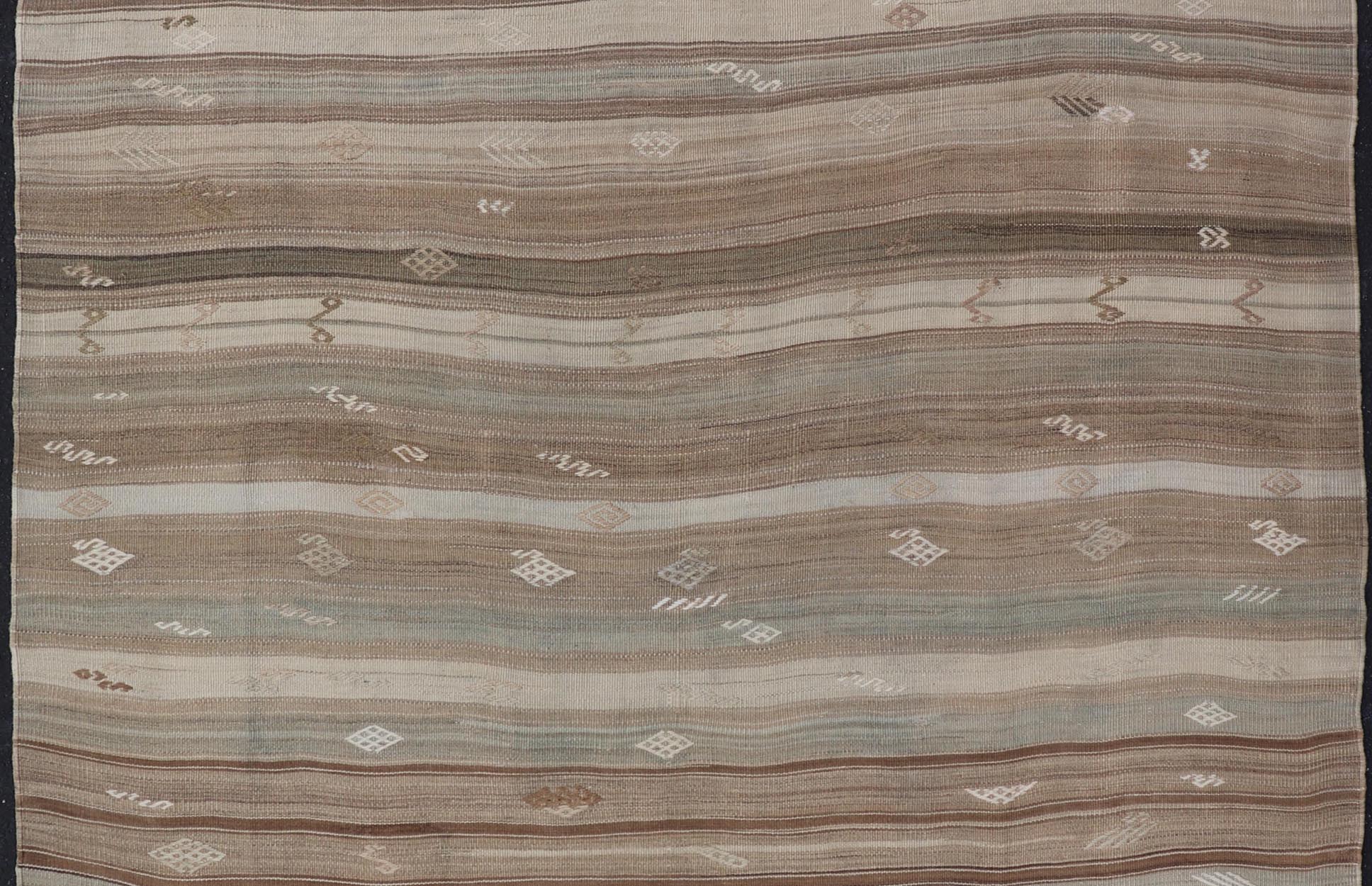 Vintage Kilim With Subtle Striped Patterns in Earth Tones Measures: 6'4" x 7'10" This Vintage Turkish Kilim showcases a flat weave with subtle patterns scattered across horizontal stripes. The kilim is decorated with shades of beige, bro... - Keivan Woven ArtsEN - 15524 - 25853Rug