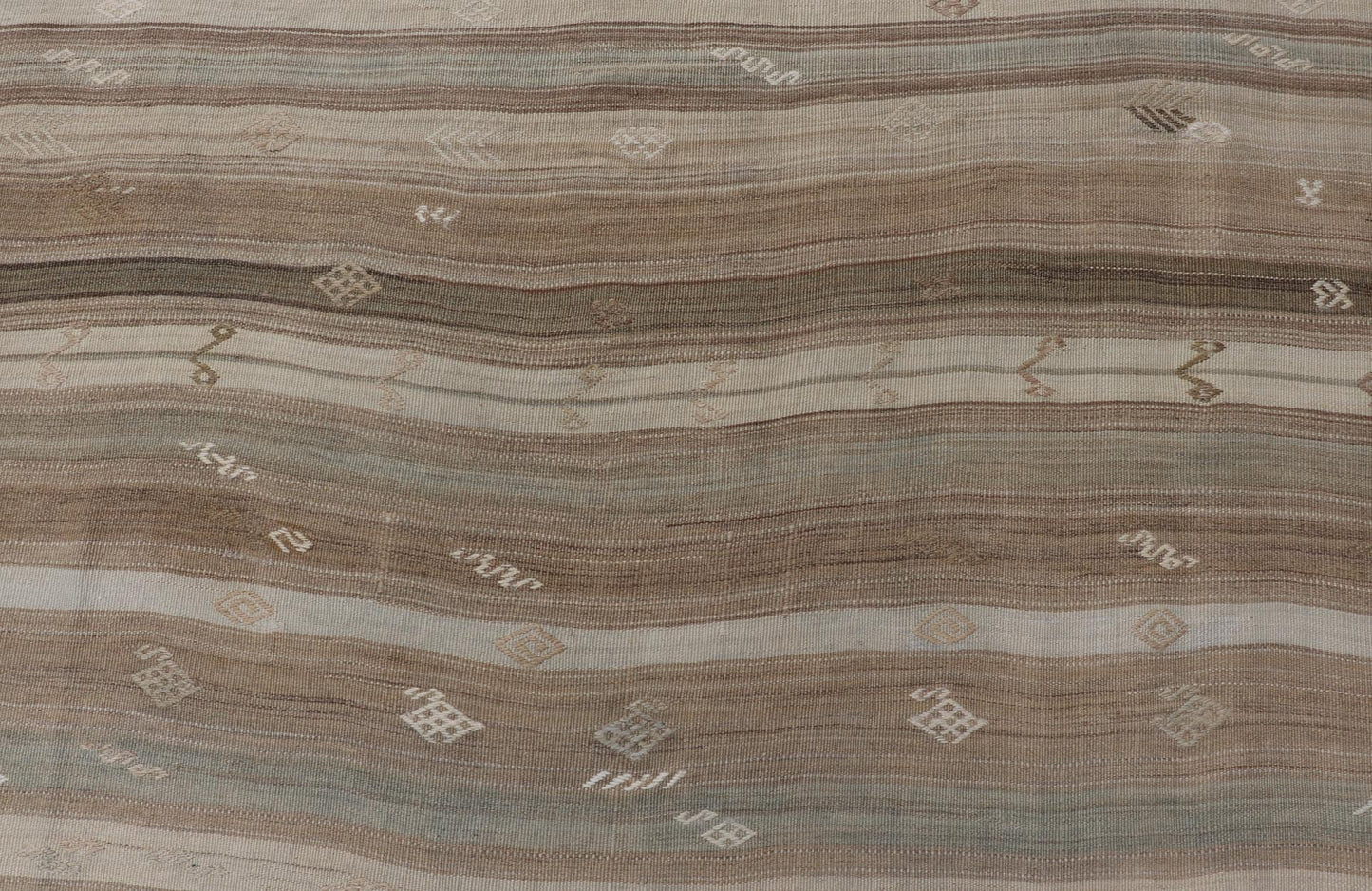 Vintage Kilim With Subtle Striped Patterns in Earth Tones Measures: 6'4" x 7'10" This Vintage Turkish Kilim showcases a flat weave with subtle patterns scattered across horizontal stripes. The kilim is decorated with shades of beige, bro... - Keivan Woven ArtsEN - 15524 - 25853Rug