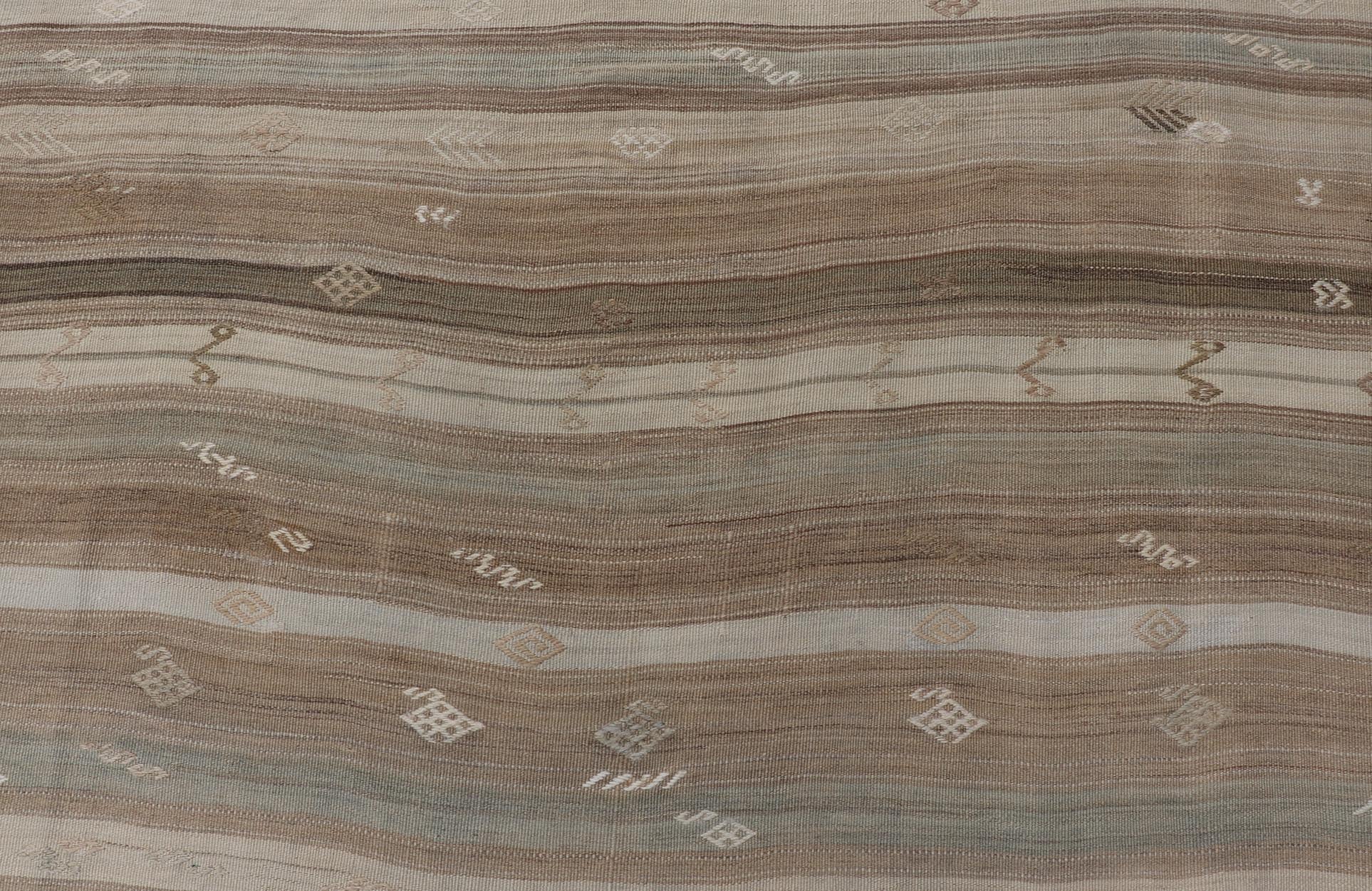 Vintage Kilim With Subtle Striped Patterns in Earth Tones Measures: 6'4" x 7'10" This Vintage Turkish Kilim showcases a flat weave with subtle patterns scattered across horizontal stripes. The kilim is decorated with shades of beige, bro... - Keivan Woven ArtsEN - 15524 - 25853Rug