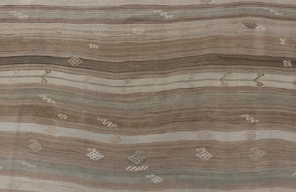Vintage Kilim With Subtle Striped Patterns in Earth Tones Measures: 6'4" x 7'10" This Vintage Turkish Kilim showcases a flat weave with subtle patterns scattered across horizontal stripes. The kilim is decorated with shades of beige, bro... - Keivan Woven ArtsEN - 15524 - 25853Rug