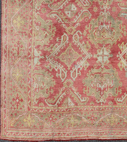 Rose red, light green and pinkish red antique Turkish Oushak rug with flowing design. Keivan Woven Arts / rug EN - 165065, country of origin type: Turkey Oushak, circa 1920. Measures: 11' x 13'7. This Oushak carpet (circa early 20th century) featur... - Keivan Woven ArtsEN - 165065 - 9420Rug