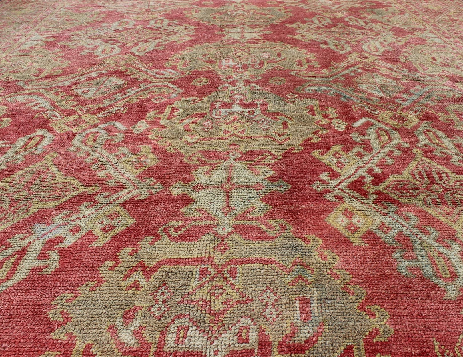 Rose red, light green and pinkish red antique Turkish Oushak rug with flowing design. Keivan Woven Arts / rug EN - 165065, country of origin type: Turkey Oushak, circa 1920. Measures: 11' x 13'7. This Oushak carpet (circa early 20th century) featur... - Keivan Woven ArtsEN - 165065 - 9420Rug