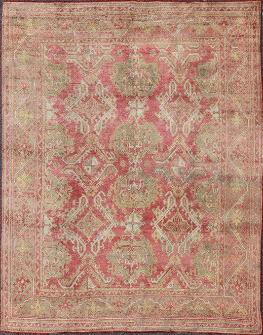 Rose red, light green and pinkish red antique Turkish Oushak rug with flowing design. Keivan Woven Arts / rug EN - 165065, country of origin type: Turkey Oushak, circa 1920. Measures: 11' x 13'7. This Oushak carpet (circa early 20th century) featur... - Keivan Woven ArtsEN - 165065 - 9420Rug