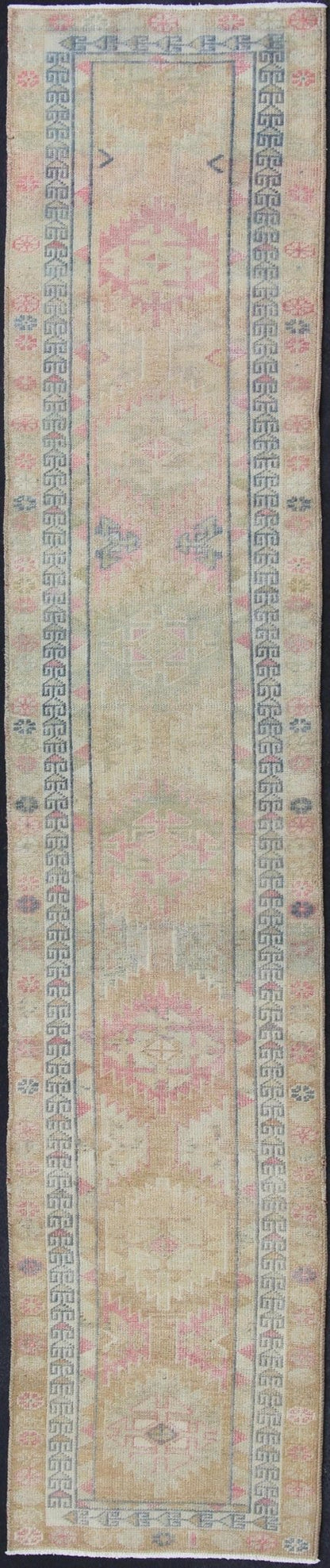 Oushak runner with tribal motifs in blue and pink, rug EN - 165353, country of origin / type: Turkey / Oushak, circa 1960 This Oushak runner from Turkey is characterized by a neutral - toned background and an assortment of tribal designs and flowers... - Keivan Woven ArtsEN - 165353 - 11421Rug