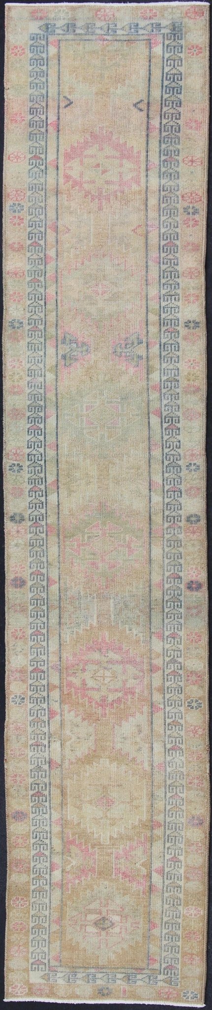 Oushak runner with tribal motifs in blue and pink, rug EN - 165353, country of origin / type: Turkey / Oushak, circa 1960 This Oushak runner from Turkey is characterized by a neutral - toned background and an assortment of tribal designs and flowers... - Keivan Woven ArtsEN - 165353 - 11421Rug