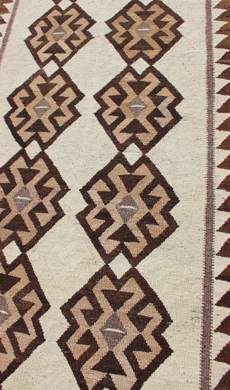 Tribal Turkish Kilim in Creams and Browns Turkish Kilim vintage runner in dark brown and cream with graphic tribal design, rug EN - 176341, country of origin / type: Turkey / Tulu, circa 1960 This unique Turkish Kilim runner features a grap... - Keivan Woven ArtsEN - 176341 - 10840Rug