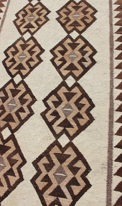 Tribal Turkish Kilim in Creams and Browns Turkish Kilim vintage runner in dark brown and cream with graphic tribal design, rug EN - 176341, country of origin / type: Turkey / Tulu, circa 1960 This unique Turkish Kilim runner features a grap... - Keivan Woven ArtsEN - 176341 - 10840Rug