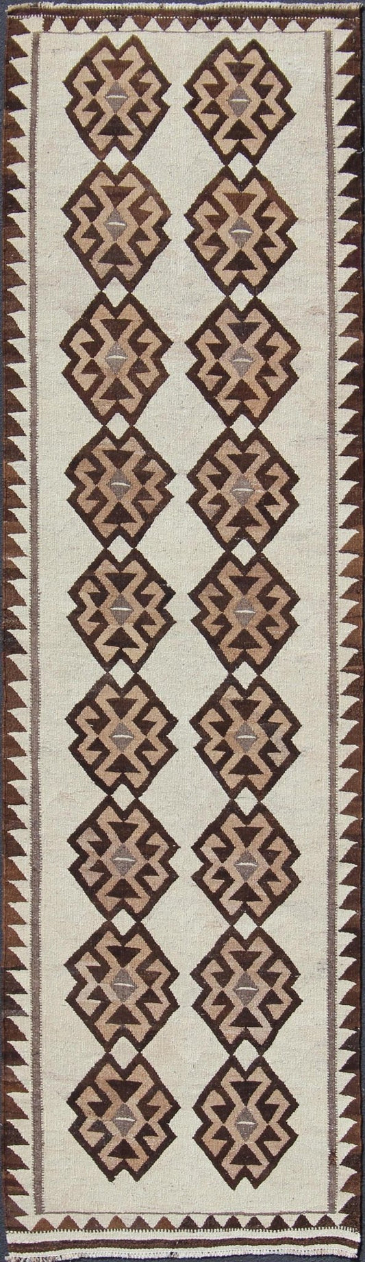 Tribal Turkish Kilim in Creams and Browns Turkish Kilim vintage runner in dark brown and cream with graphic tribal design, rug EN - 176341, country of origin / type: Turkey / Tulu, circa 1960 This unique Turkish Kilim runner features a grap... - Keivan Woven ArtsEN - 176341 - 10840