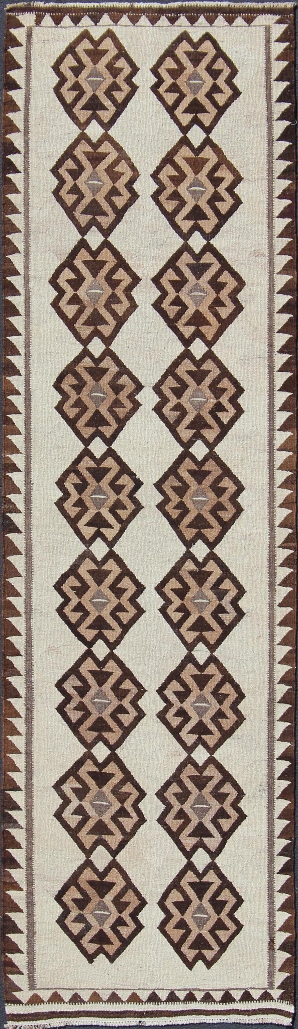 Tribal Turkish Kilim in Creams and Browns Turkish Kilim vintage runner in dark brown and cream with graphic tribal design, rug EN - 176341, country of origin / type: Turkey / Tulu, circa 1960 This unique Turkish Kilim runner features a grap... - Keivan Woven ArtsEN - 176341 - 10840Rug