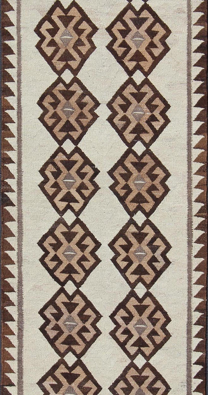 Tribal Turkish Kilim in Creams and Browns Turkish Kilim vintage runner in dark brown and cream with graphic tribal design, rug EN - 176341, country of origin / type: Turkey / Tulu, circa 1960 This unique Turkish Kilim runner features a grap... - Keivan Woven ArtsEN - 176341 - 10840Rug