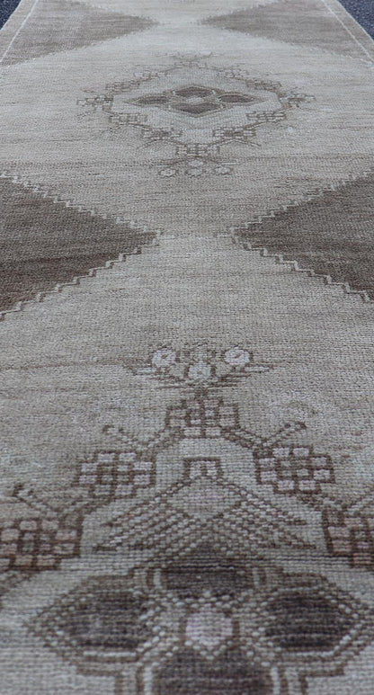 Measures: 2'10 x 13'3 Vintage Turkish Oushak Runner Neutral and Warm Colors with Tribal Medallions. rug/EN - 176926 Keivan Woven Arts / Vintage Oushak runner. Turkey mid20th century. This vintage Oushak carpet from mid - 20th century Turkey feature... - Keivan Woven ArtsEN - 176926 - 21712Rug