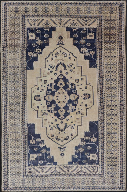 Vintage Hand - Knotted Turkish Oushak in Wool with Sub - Geometric Medallion Design This vintage Turkish Oushak rug has been hand - knotted in wool and features a large central medallion design rendered in blue, cream, tan and ivory tones. A compleme... - Keivan Woven ArtsEN - 178064 - 19508