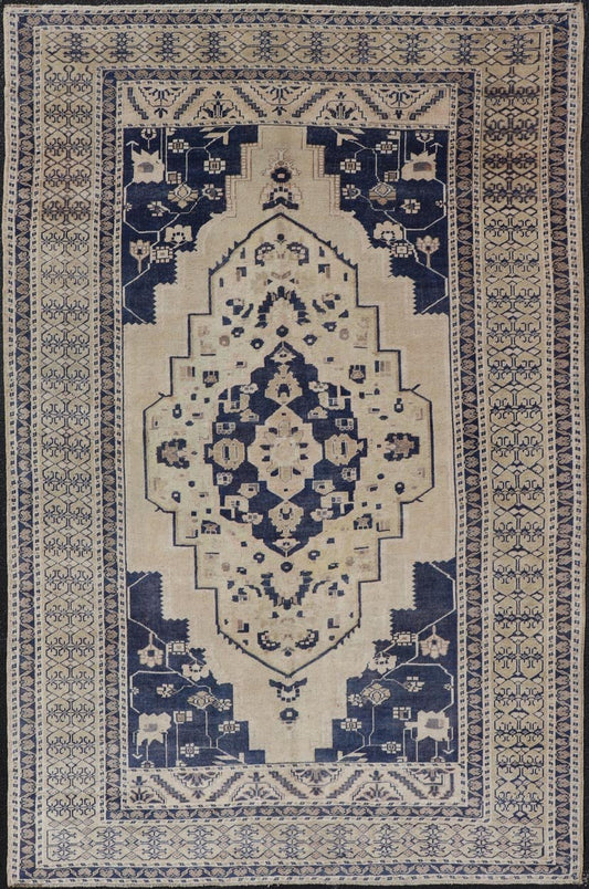 Vintage Hand - Knotted Turkish Oushak in Wool with Sub - Geometric Medallion Design This vintage Turkish Oushak rug has been hand - knotted in wool and features a large central medallion design rendered in blue, cream, tan and ivory tones. A compleme... - Keivan Woven ArtsEN - 178064 - 19508