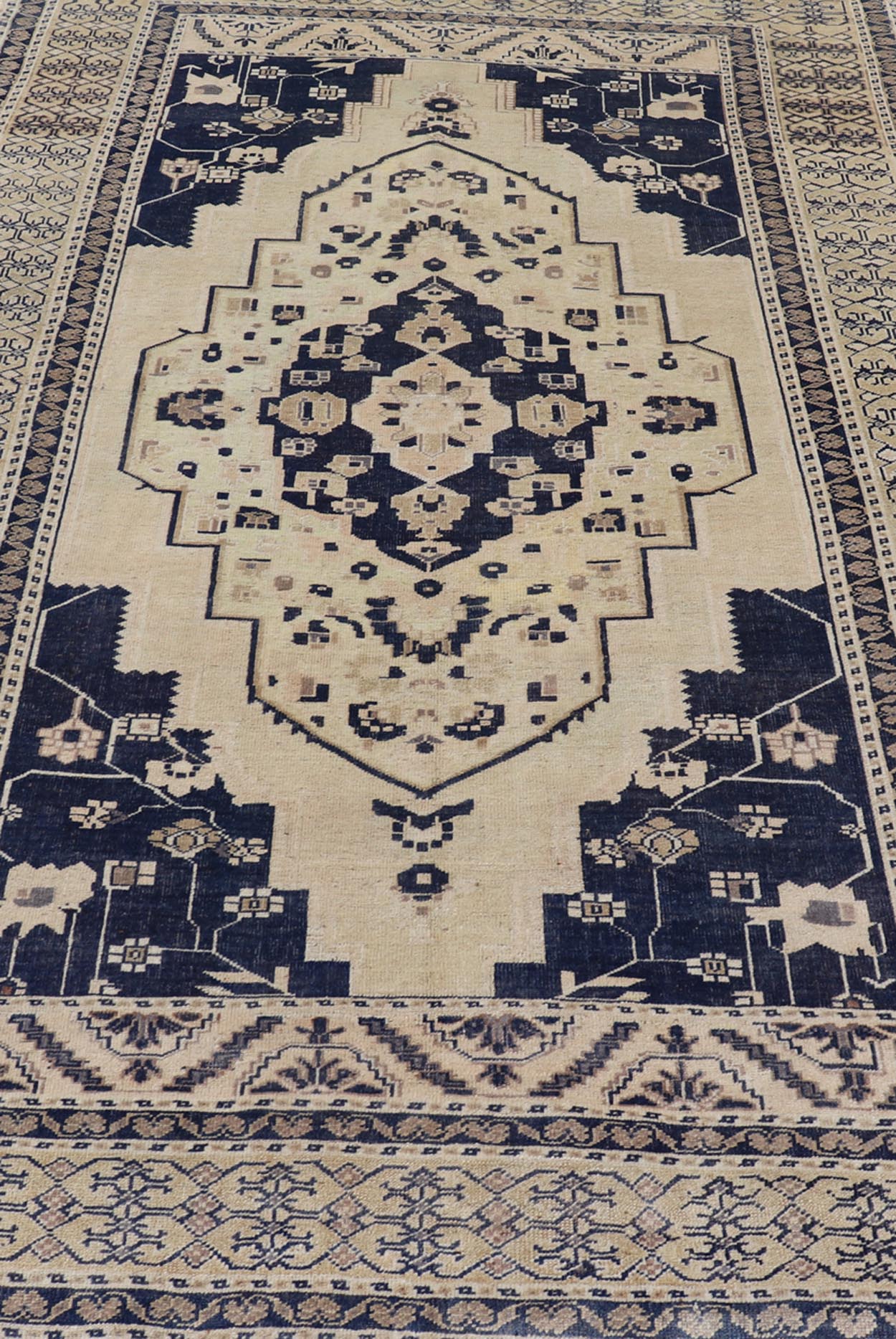 Vintage Hand - Knotted Turkish Oushak in Wool with Sub - Geometric Medallion Design This vintage Turkish Oushak rug has been hand - knotted in wool and features a large central medallion design rendered in blue, cream, tan and ivory tones. A compleme... - Keivan Woven ArtsEN - 178064 - 19508