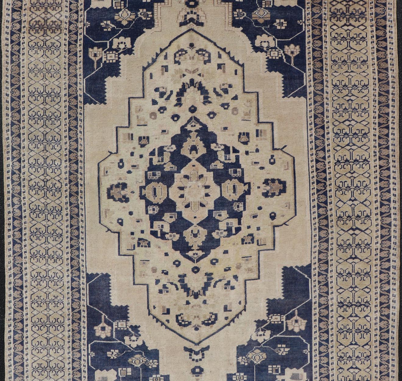 Vintage Hand - Knotted Turkish Oushak in Wool with Sub - Geometric Medallion Design This vintage Turkish Oushak rug has been hand - knotted in wool and features a large central medallion design rendered in blue, cream, tan and ivory tones. A compleme... - Keivan Woven ArtsEN - 178064 - 19508
