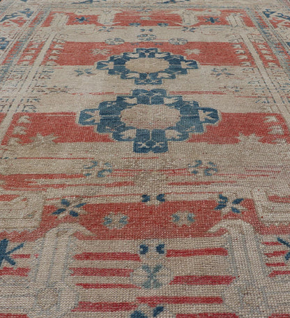 Tribal Medallion Design Vintage Turkish Oushak in Cream, Blue, and Terracotta Measures: 4'5 x 6'7 This vintage Oushak has repeating motifs in terracotta, cream, and blue encasing multiple motifs and the striped field. The eccentric fiel... - Keivan Woven ArtsEN - 178200 - 18884Rug