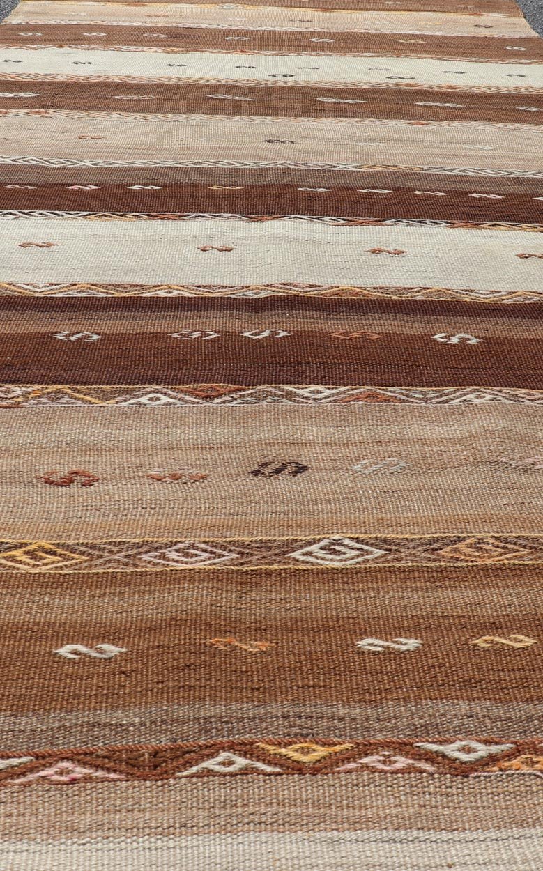 Vintage Earthy Kilim Gallery Runner with Stripe Design in Multi Colors & Motif's. Keivan Woven Arts / rug EN - 178669, country of origin / type: Turkey / Kilim, circa 1950. Measures: 4'6 x 11'7 Featuring a striking stripe design, this unique mid - c... - Keivan Woven ArtsEN - 178669 - 23504Rug