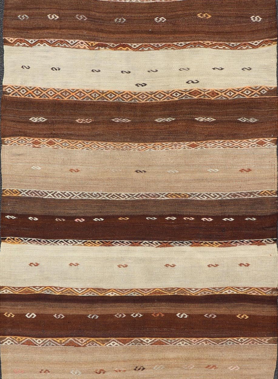 Vintage Earthy Kilim Gallery Runner with Stripe Design in Multi Colors & Motif's. Keivan Woven Arts / rug EN - 178669, country of origin / type: Turkey / Kilim, circa 1950. Measures: 4'6 x 11'7 Featuring a striking stripe design, this unique mid - c... - Keivan Woven ArtsEN - 178669 - 23504Rug