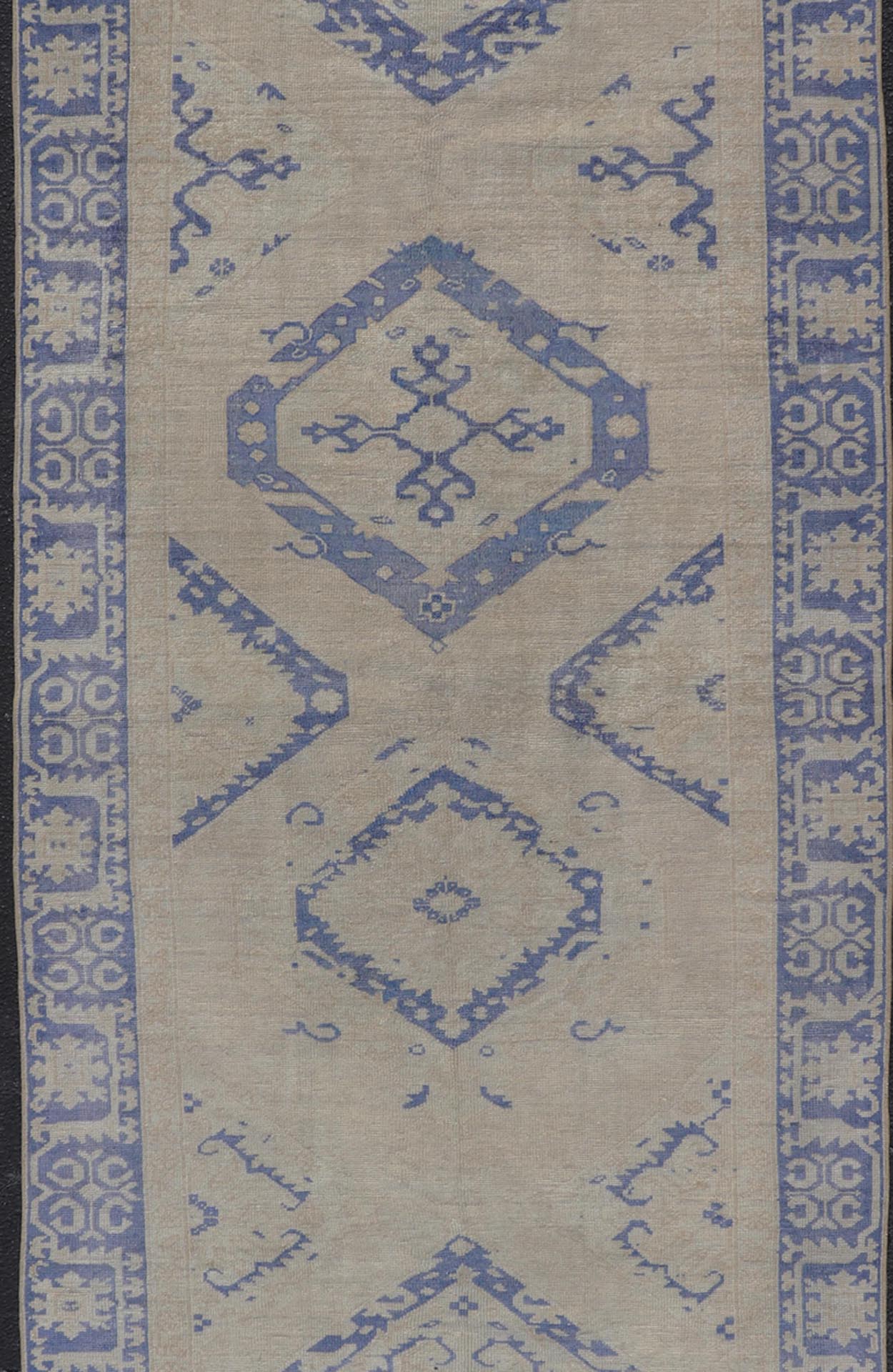Turkish Oushak Gallery Rug in Blue and Cream with Geometric Design Measures: 4'6 x 12'6 This vintage Oushak gallery runner features blue medallions on a sandy - taupe field. The border and central medallions are both rendered in a rich me... - Keivan Woven ArtsEN - 178699 - 18896Rug